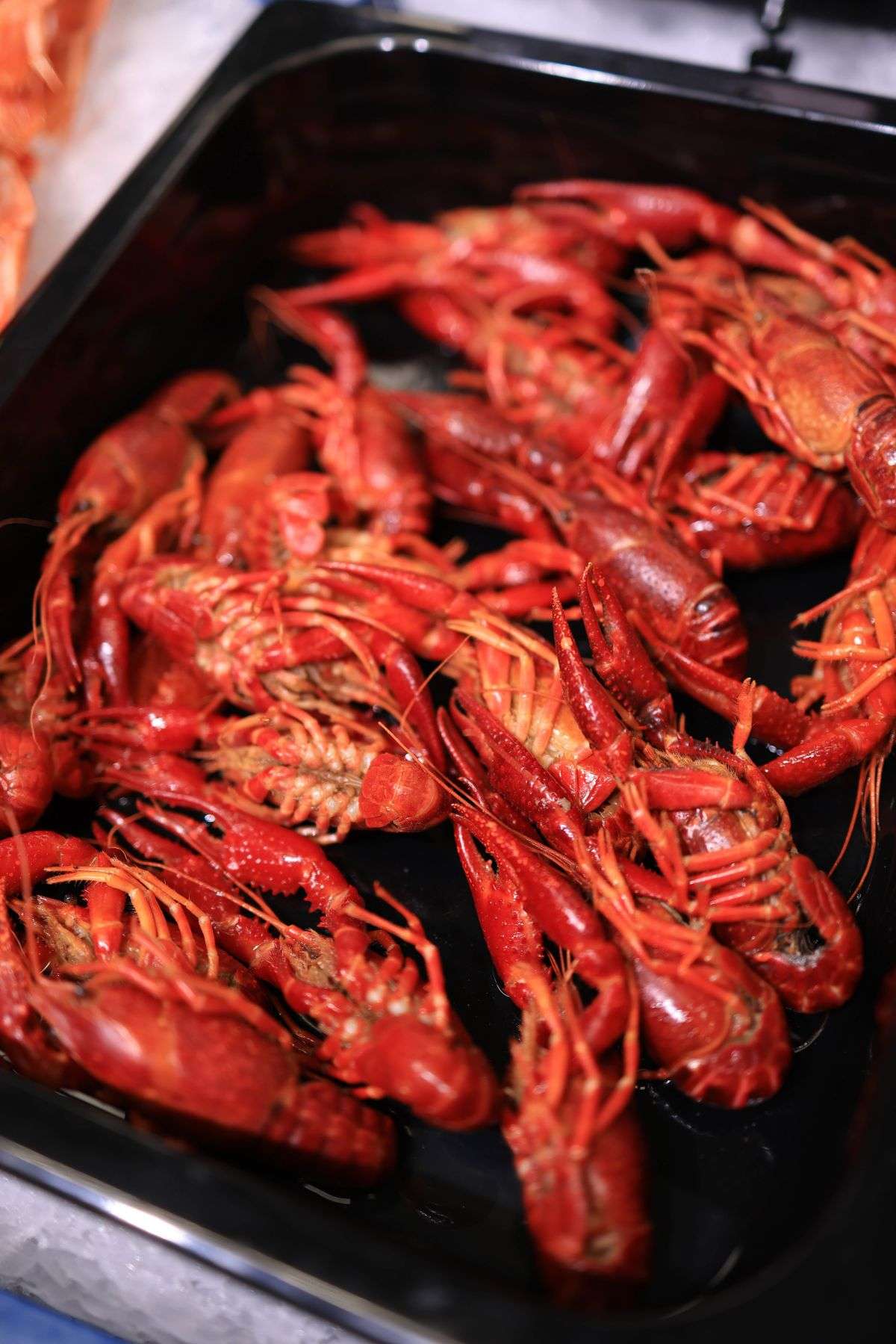 A heaping tray of boiled crawfish ready for a seafood feast