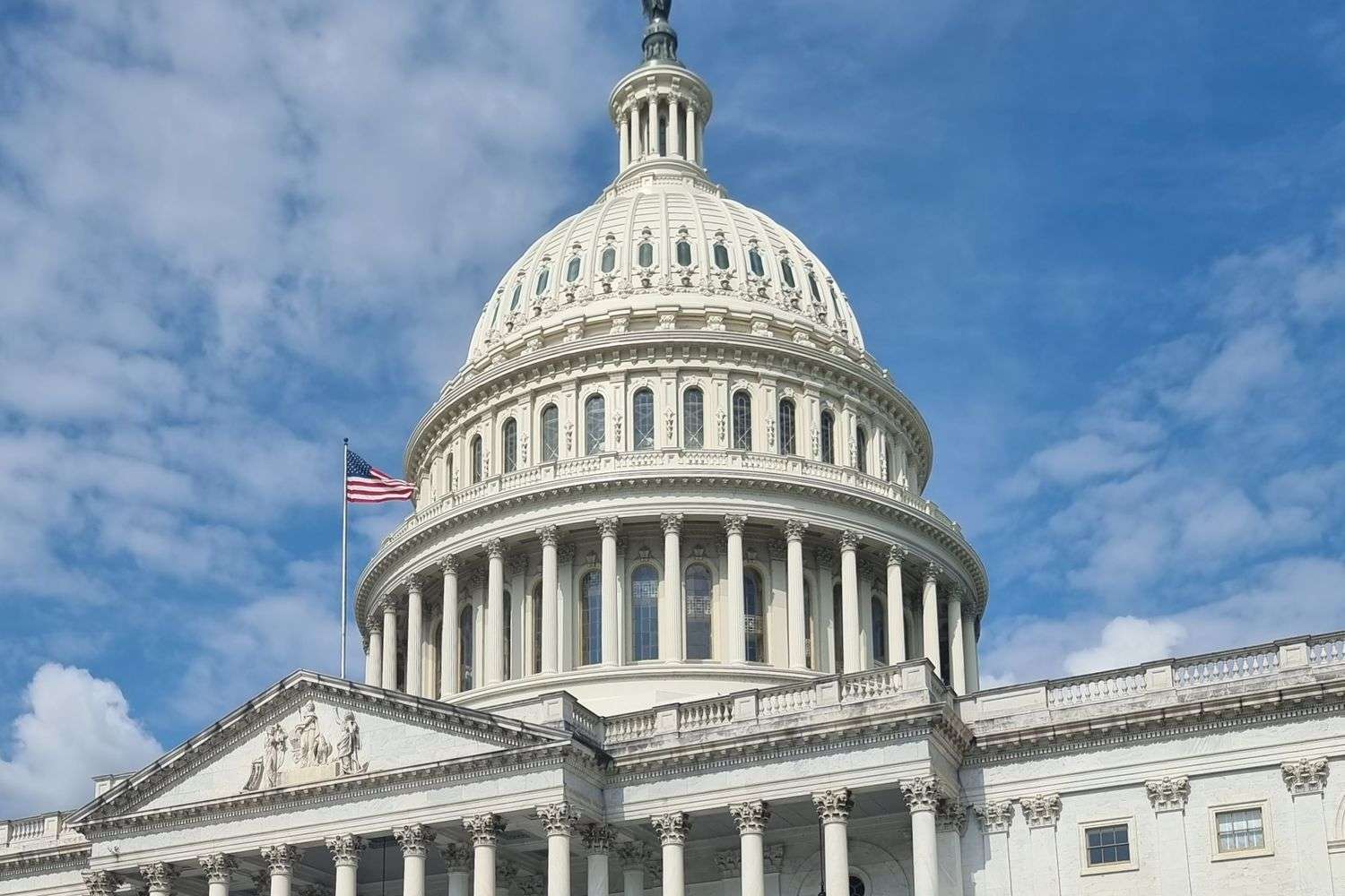 The United States Capitol dome against a clear sky