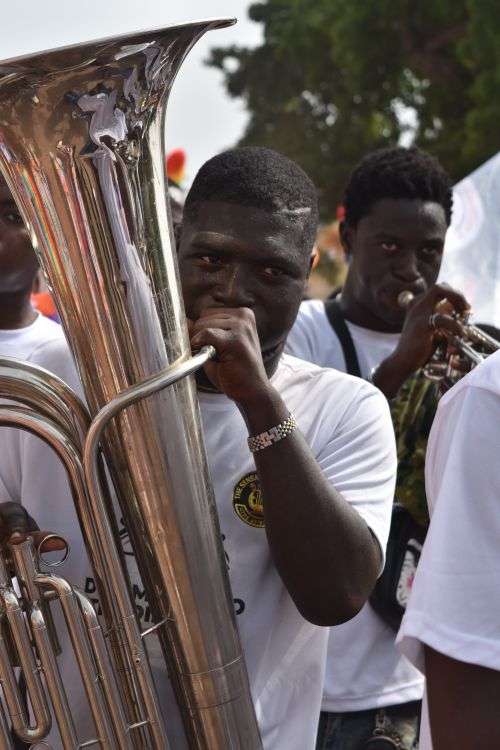 Brass band musicians playing instruments at an outdoor festival