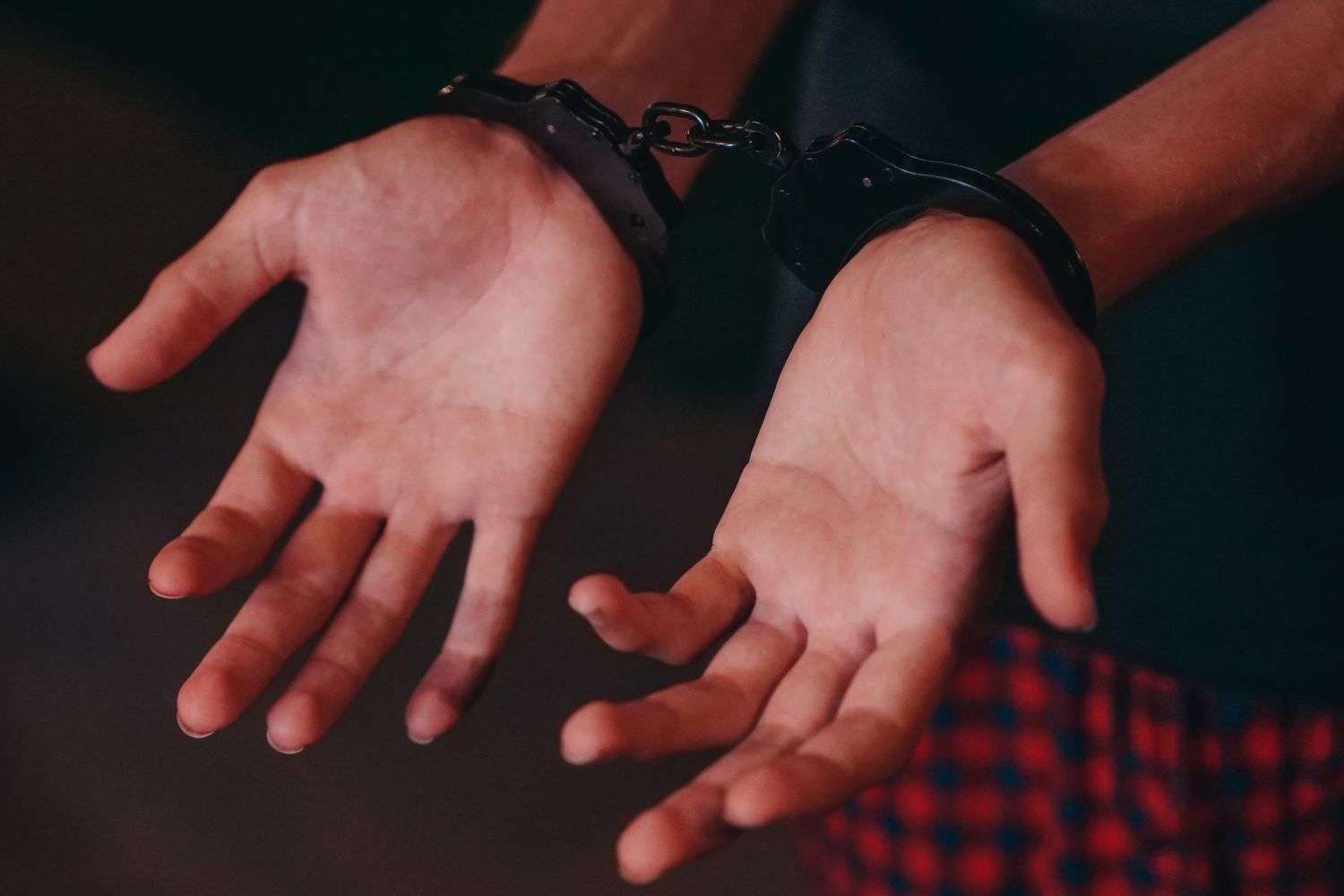 Handcuffs held by a law enforcement officer during an arrest