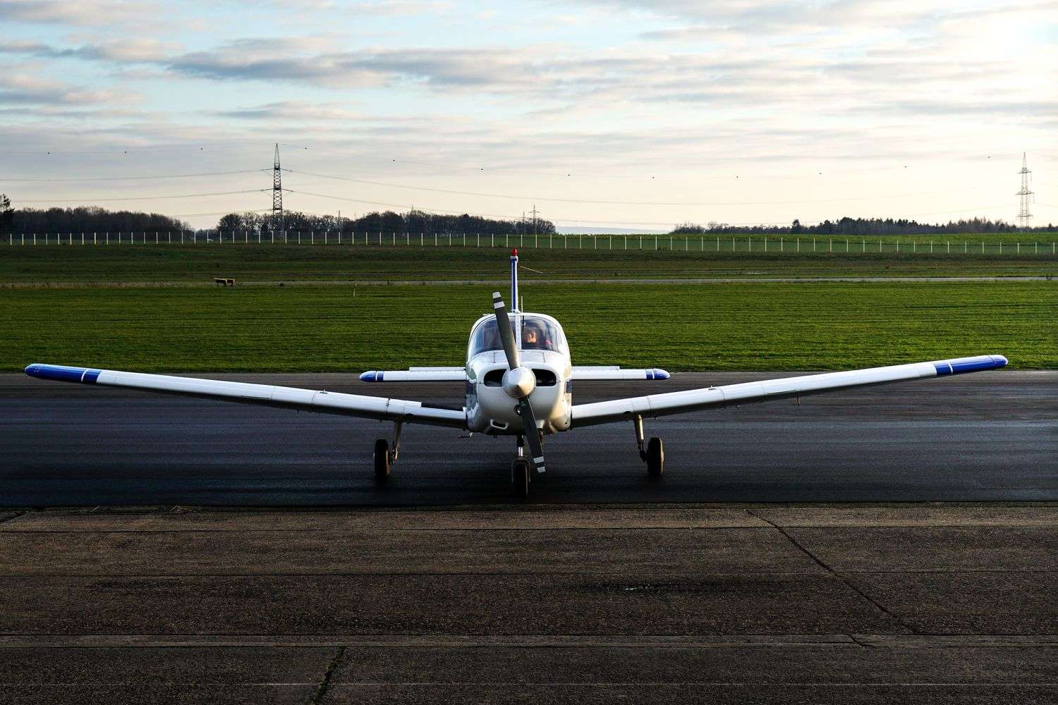 A small single-engine plane parked on an airport tarmac