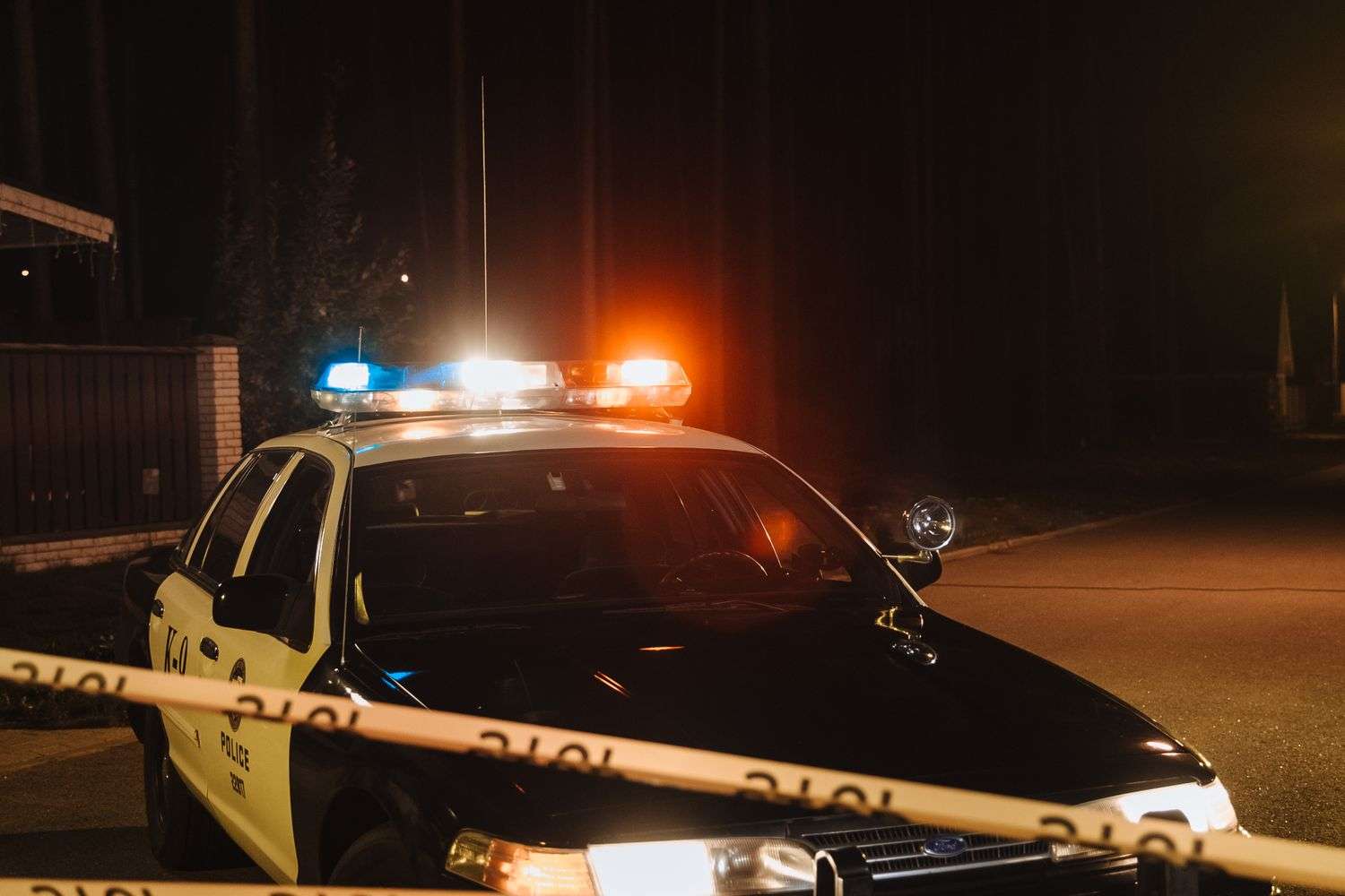 Law enforcement personnel investigating a vehicle-related death scene