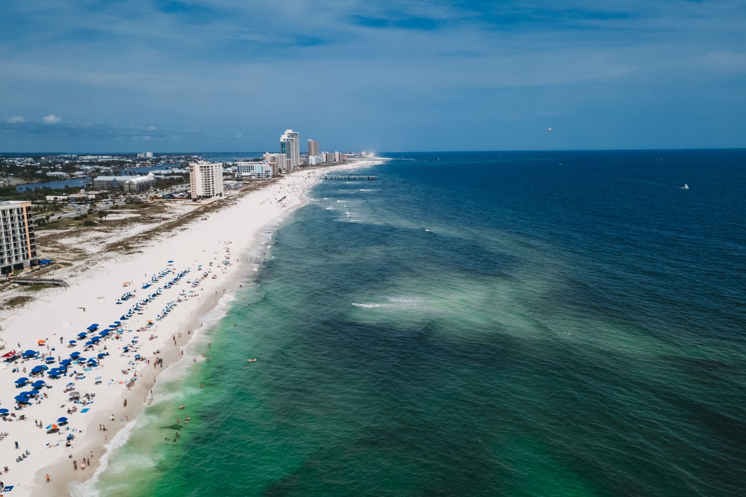 Wide sandy beach with emerald water on the Alabama Gulf Coast