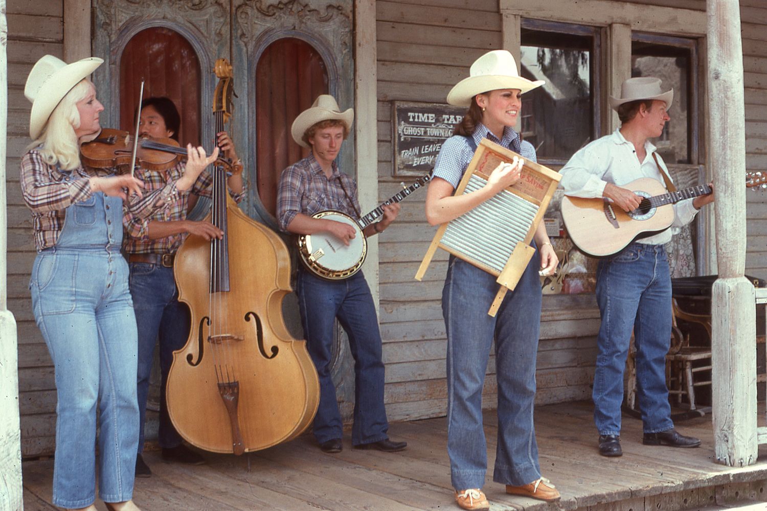 Bluegrass musicians with guitars at a small venue show