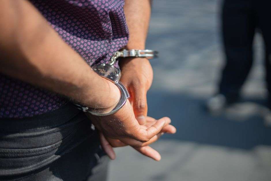 Close-up of handcuffs representing a criminal arrest