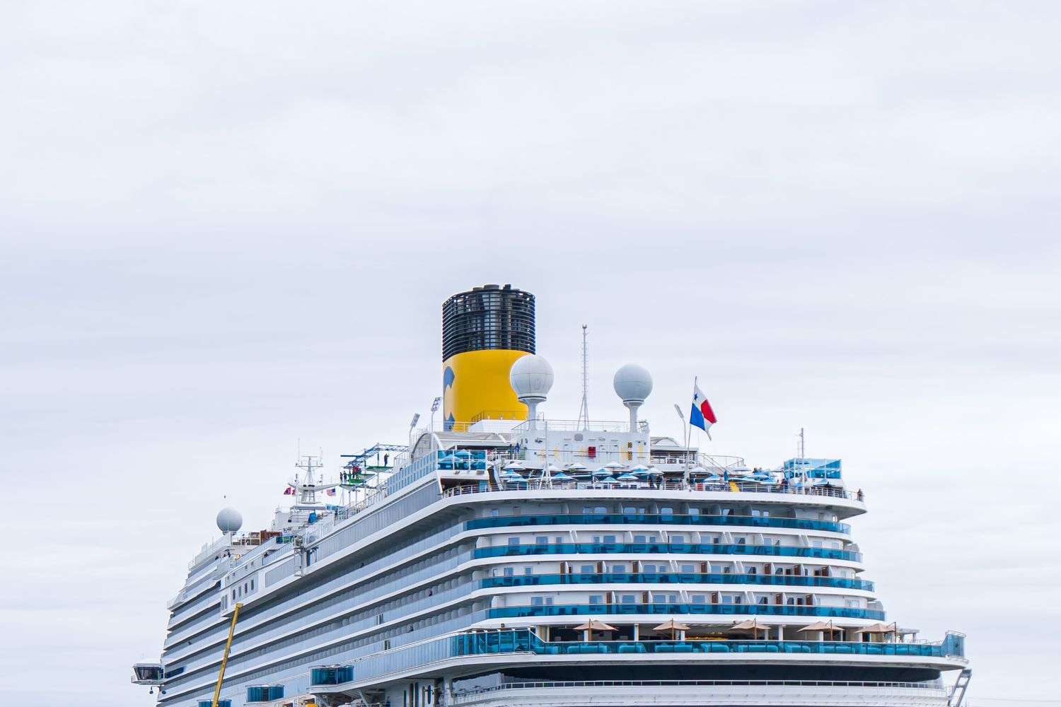 A large cruise ship moored at a harbor terminal