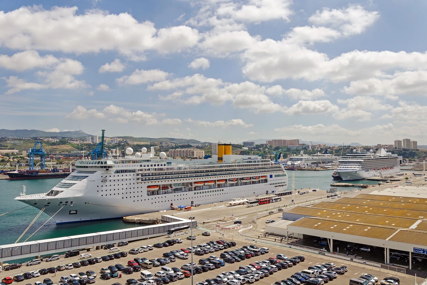 A large cruise ship docked at a port terminal on the Gulf Coast