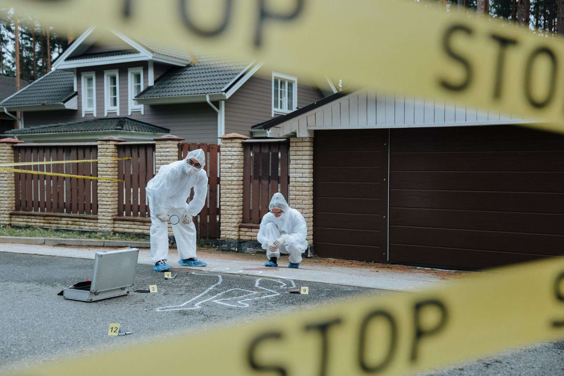 Police crime scene tape stretched across a park pathway during an investigation