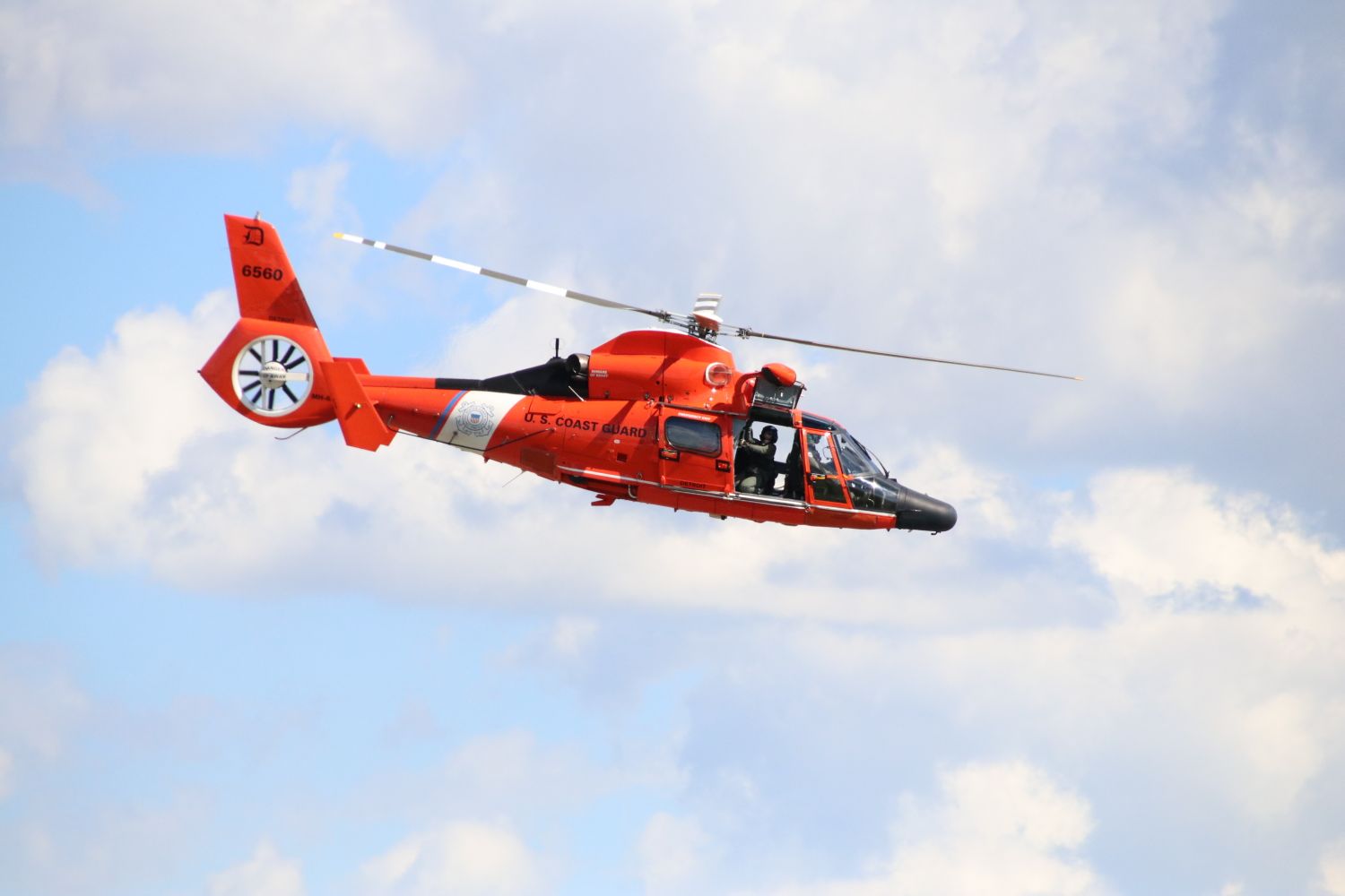 Coast Guard MH-65 Dolphin helicopter in flight over open water