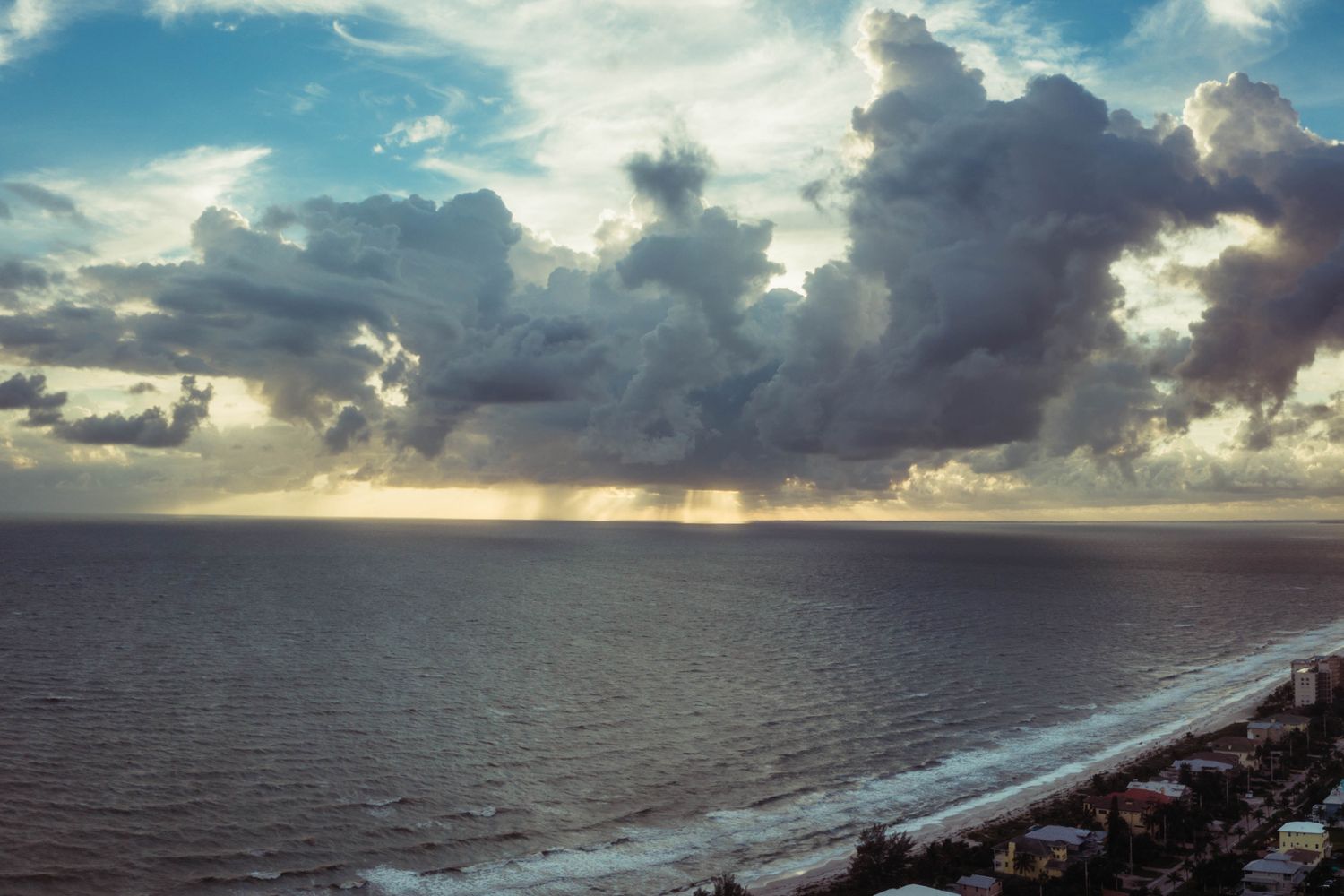 Dark storm clouds gathering over a Gulf Coast community