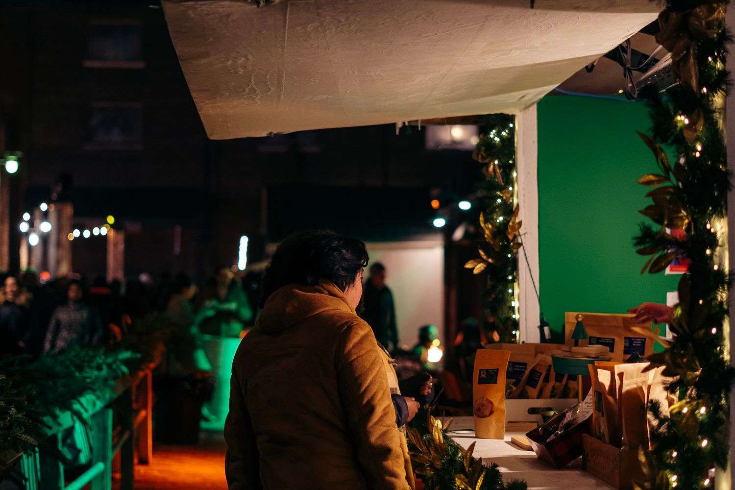 Shoppers browse vendor booths at a Christmas market