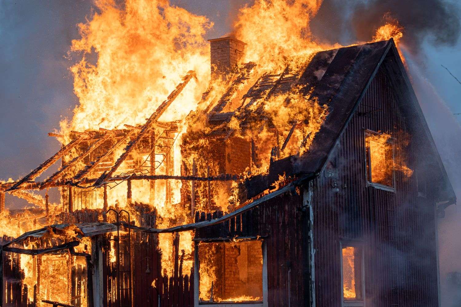 Smoke and flames visible from a house fire