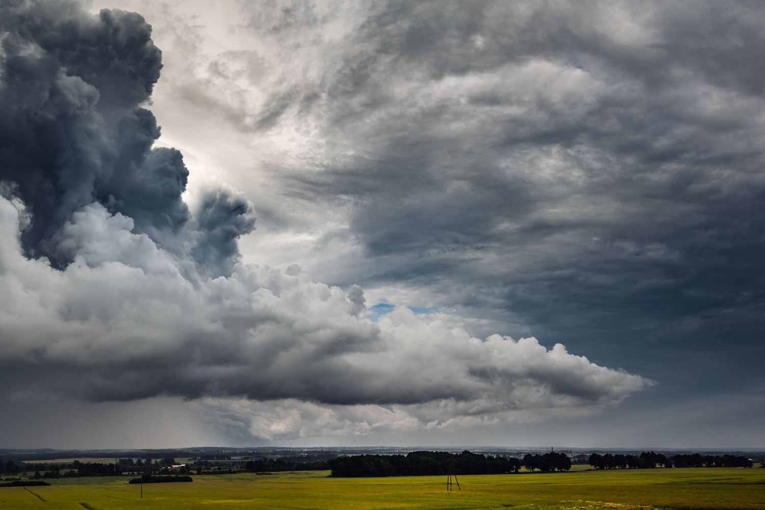 Dark storm clouds gathering over a rural landscape