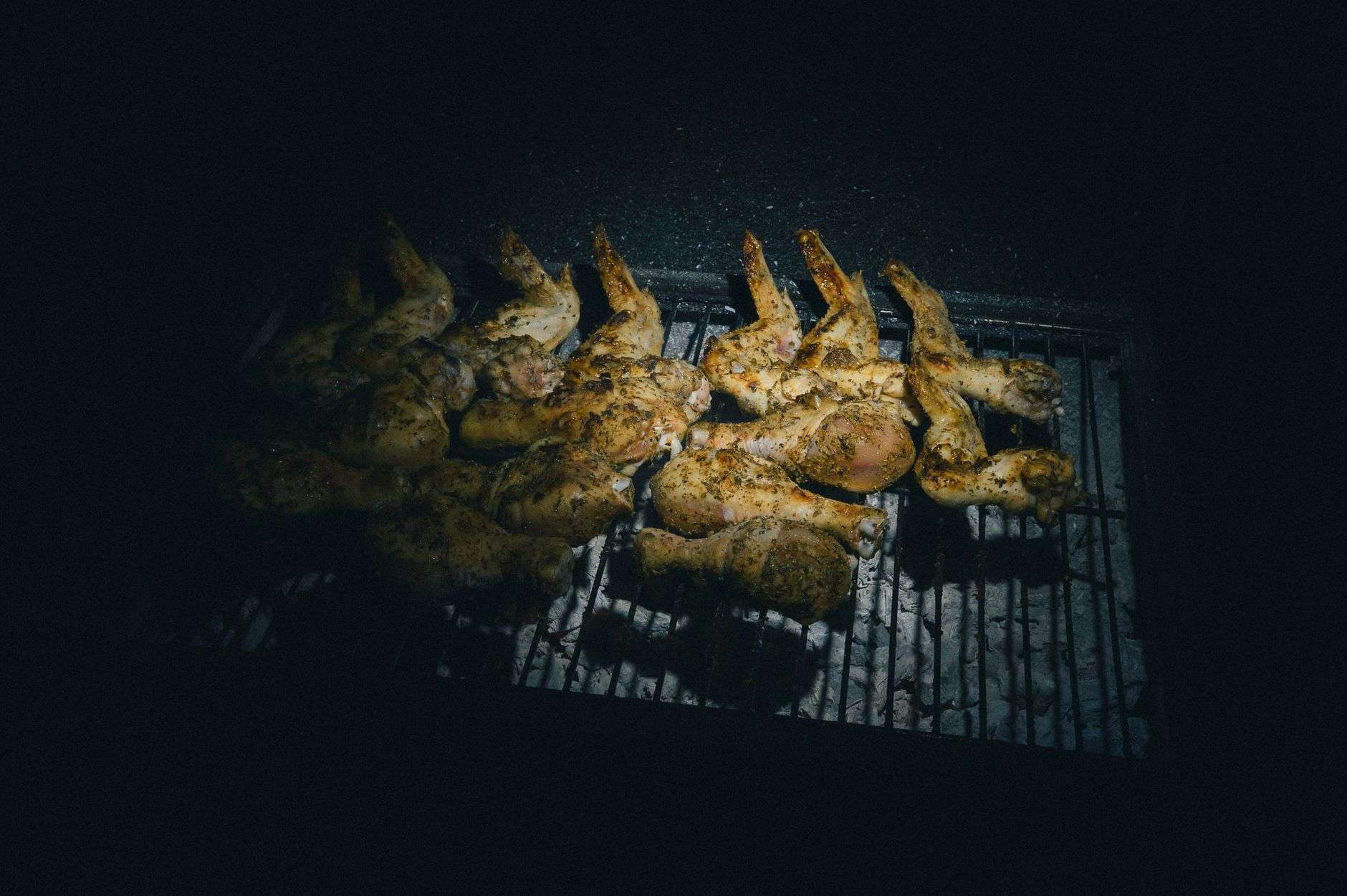 Cooks grilling food at an outdoor tailgate-style cooking competition