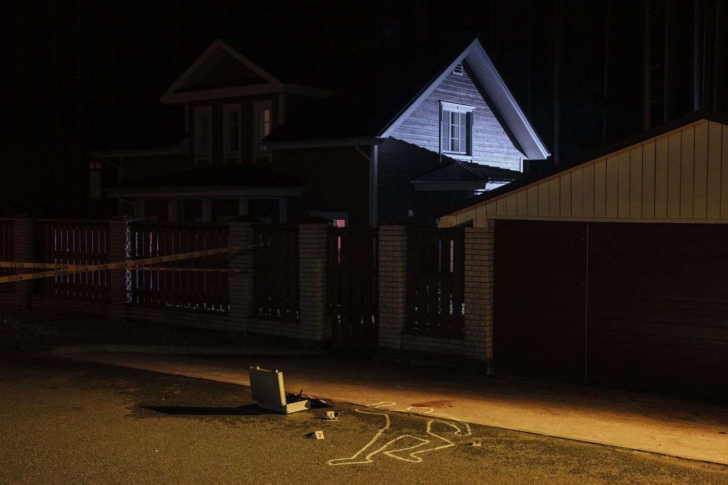 Crime scene tape stretched across a residential street in Mobile, Alabama