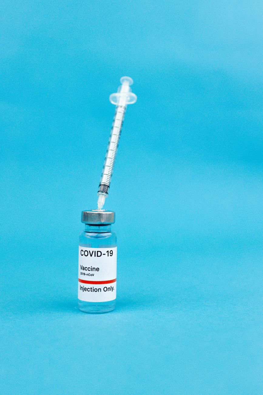 Vial and syringe labeled COVID-19 vaccine