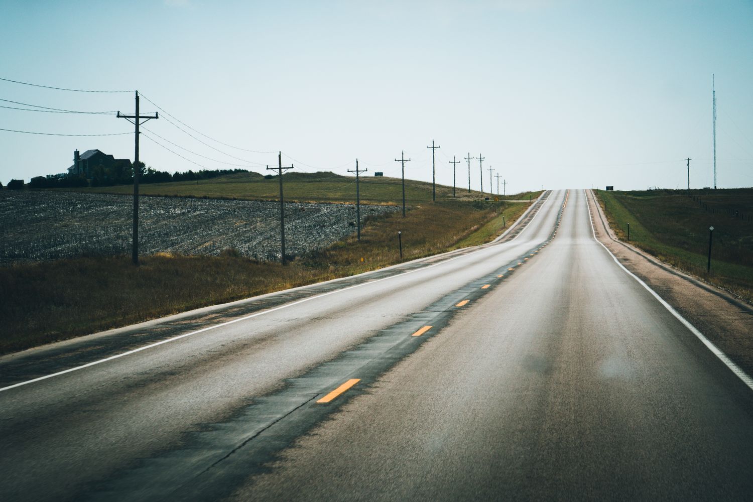 Two-lane rural highway passing farmland in Northwest Florida