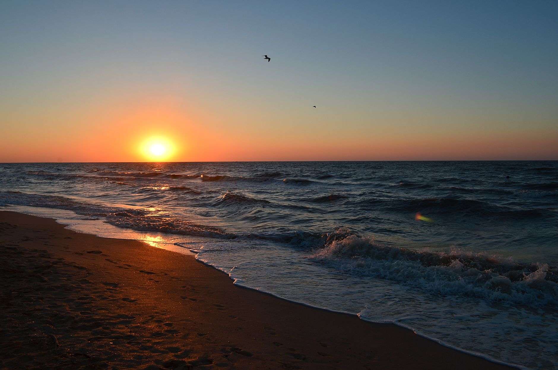 A hazy summer sky over a Gulf Coast beach on a hot, humid day