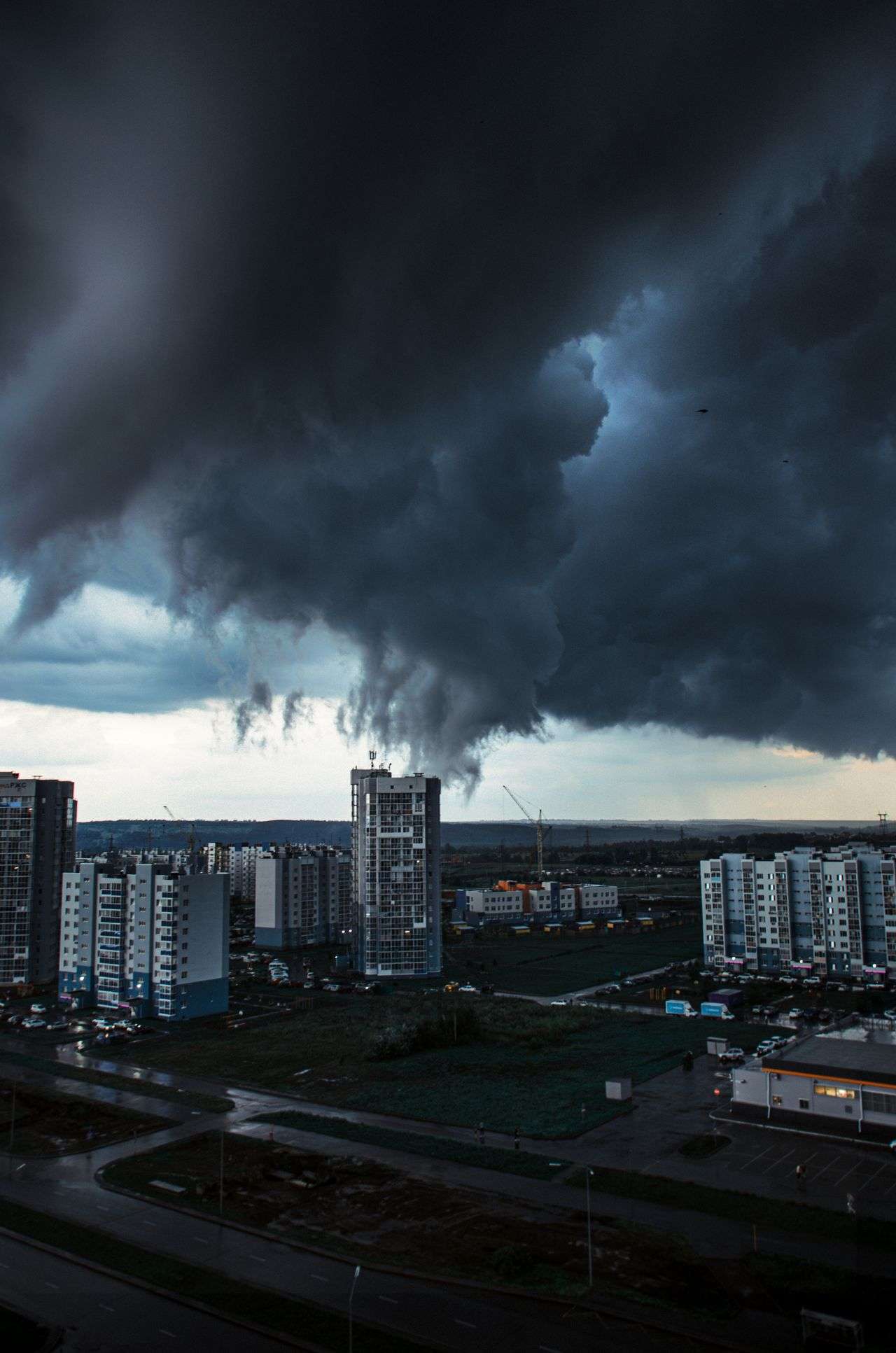 Dark storm clouds gathering over a city skyline