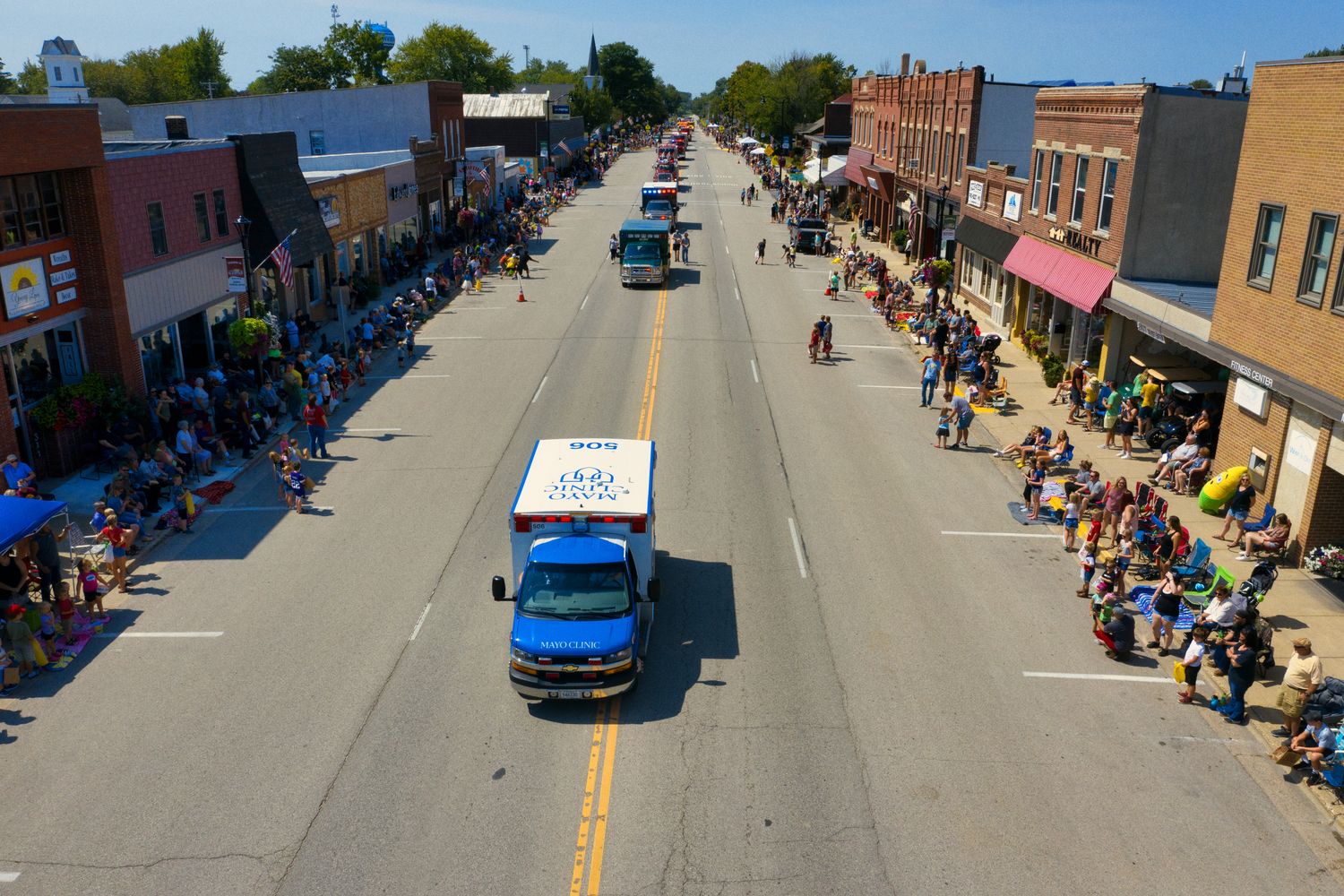 A parade passing along a street lined with spectators
