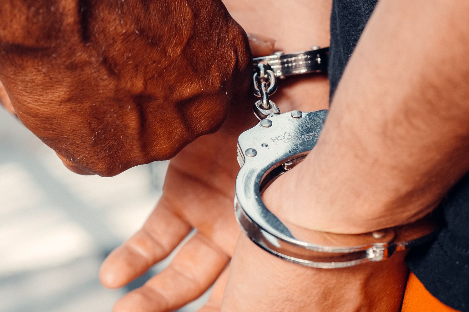 Handcuffs resting near a police vehicle during an arrest