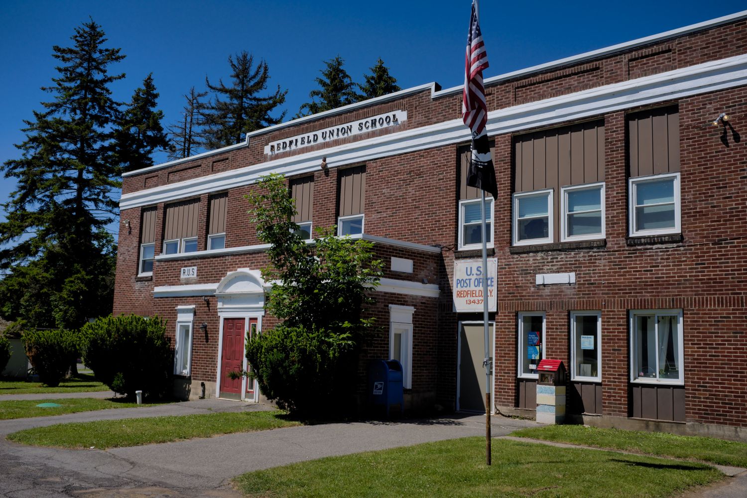 A middle school campus building with an American flag out front