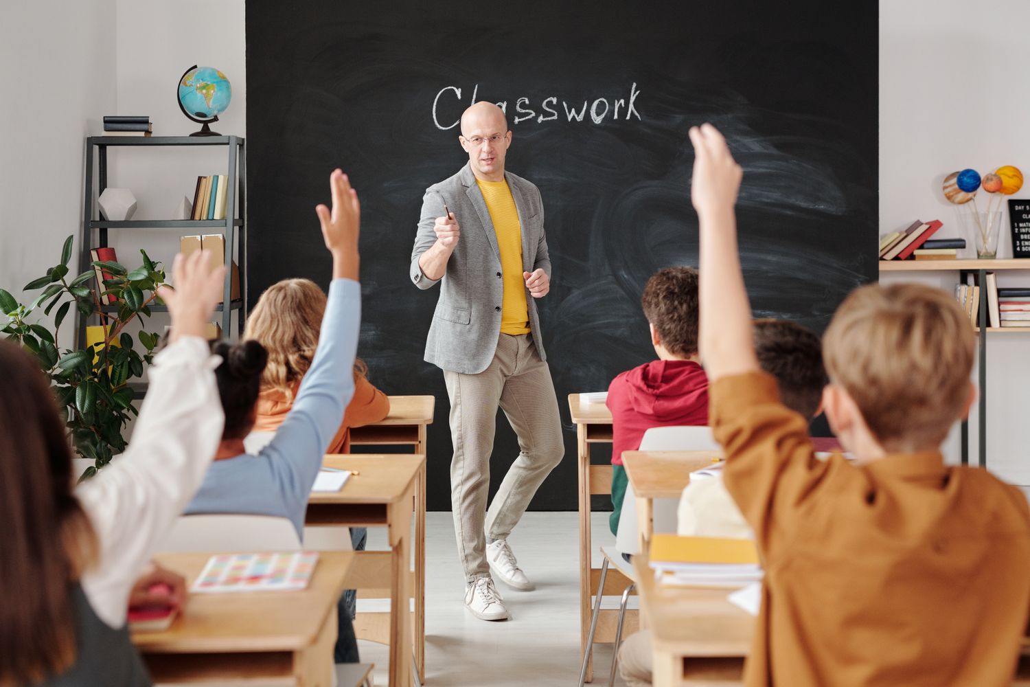 A teacher working with students in a classroom