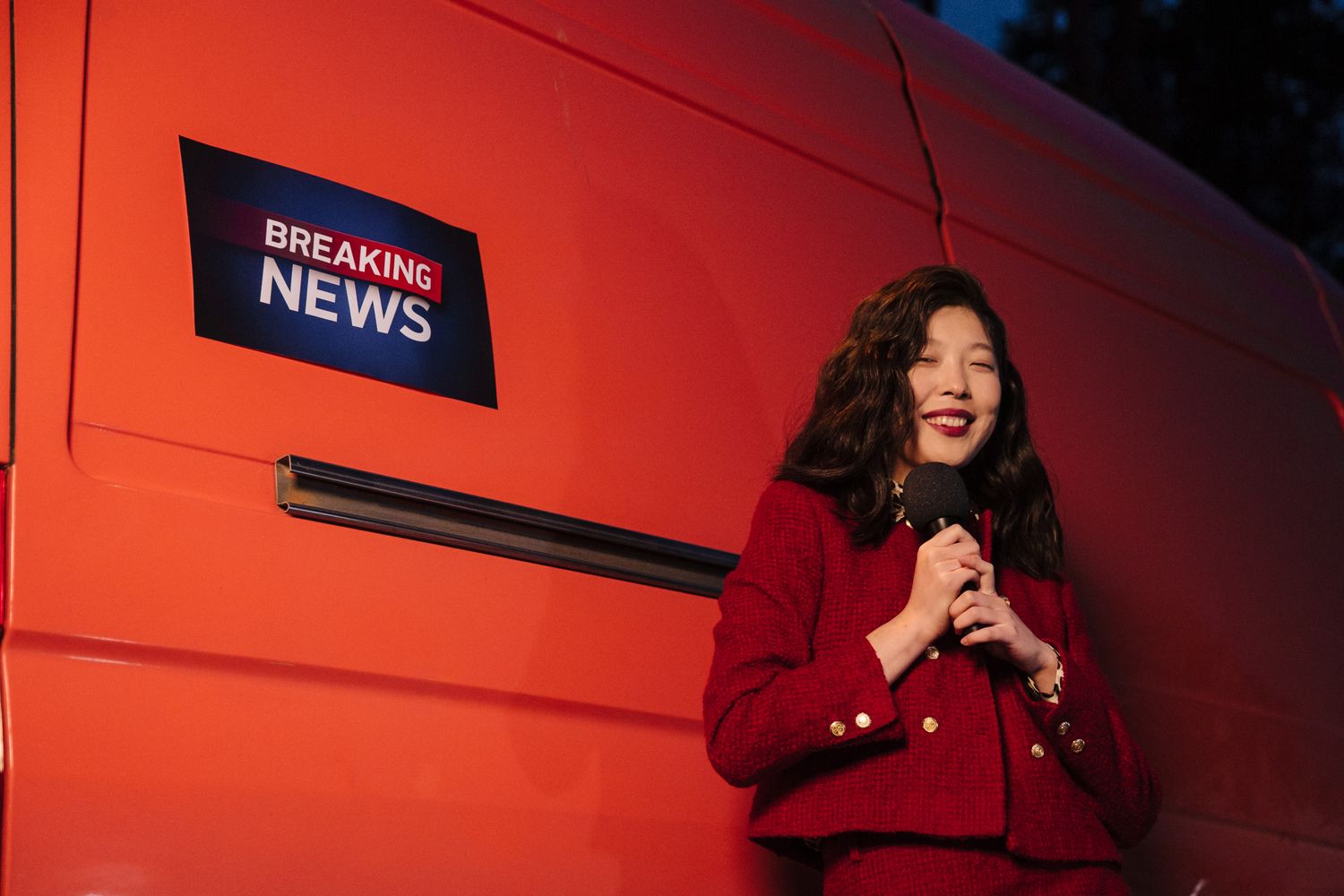 Professional television news anchor working at the studio desk