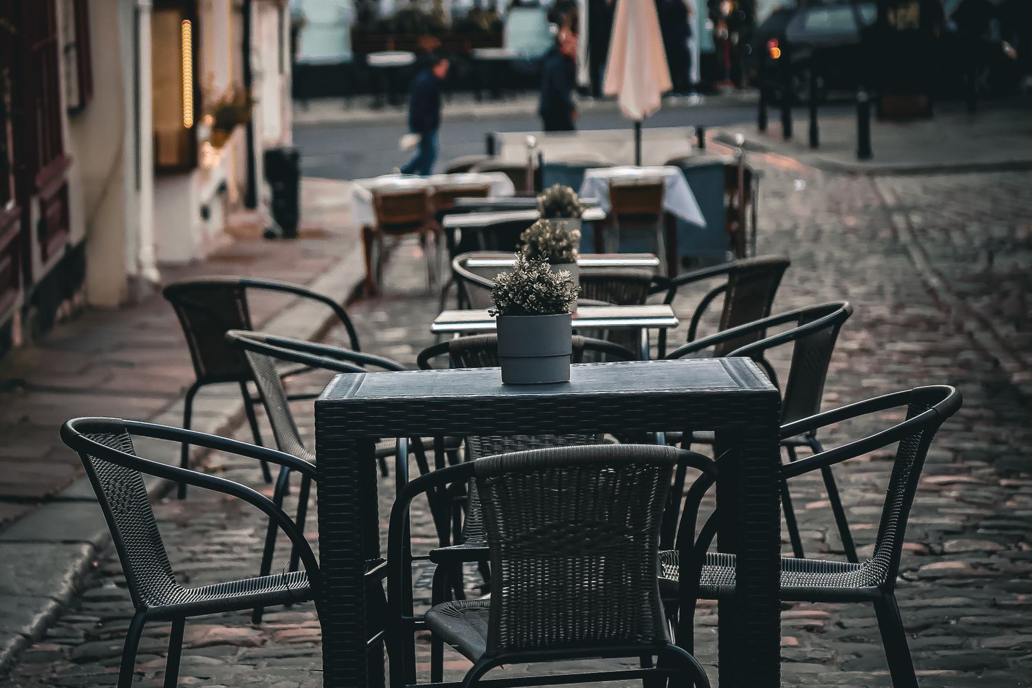Outdoor restaurant tables set up along a downtown street