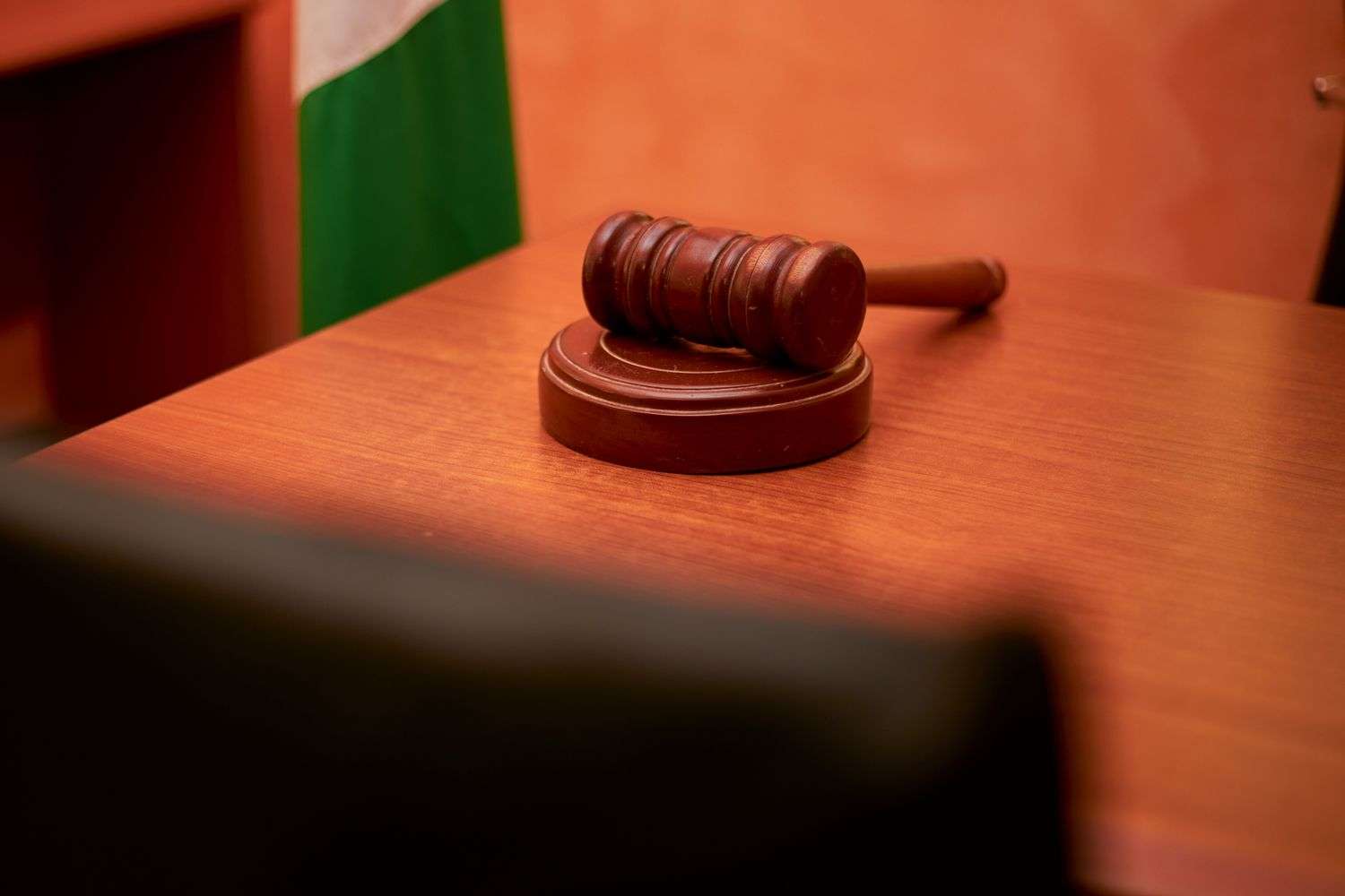 Wooden gavel resting on a judge's bench