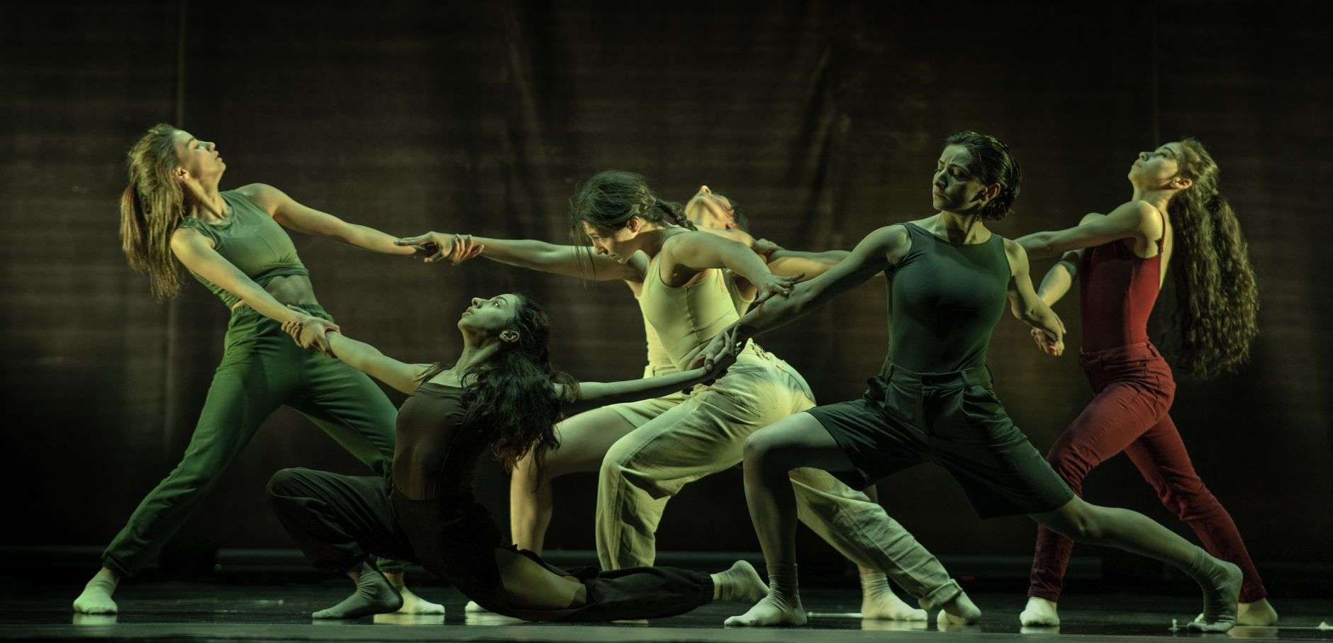 A dancer performing on stage during a contemporary dance piece