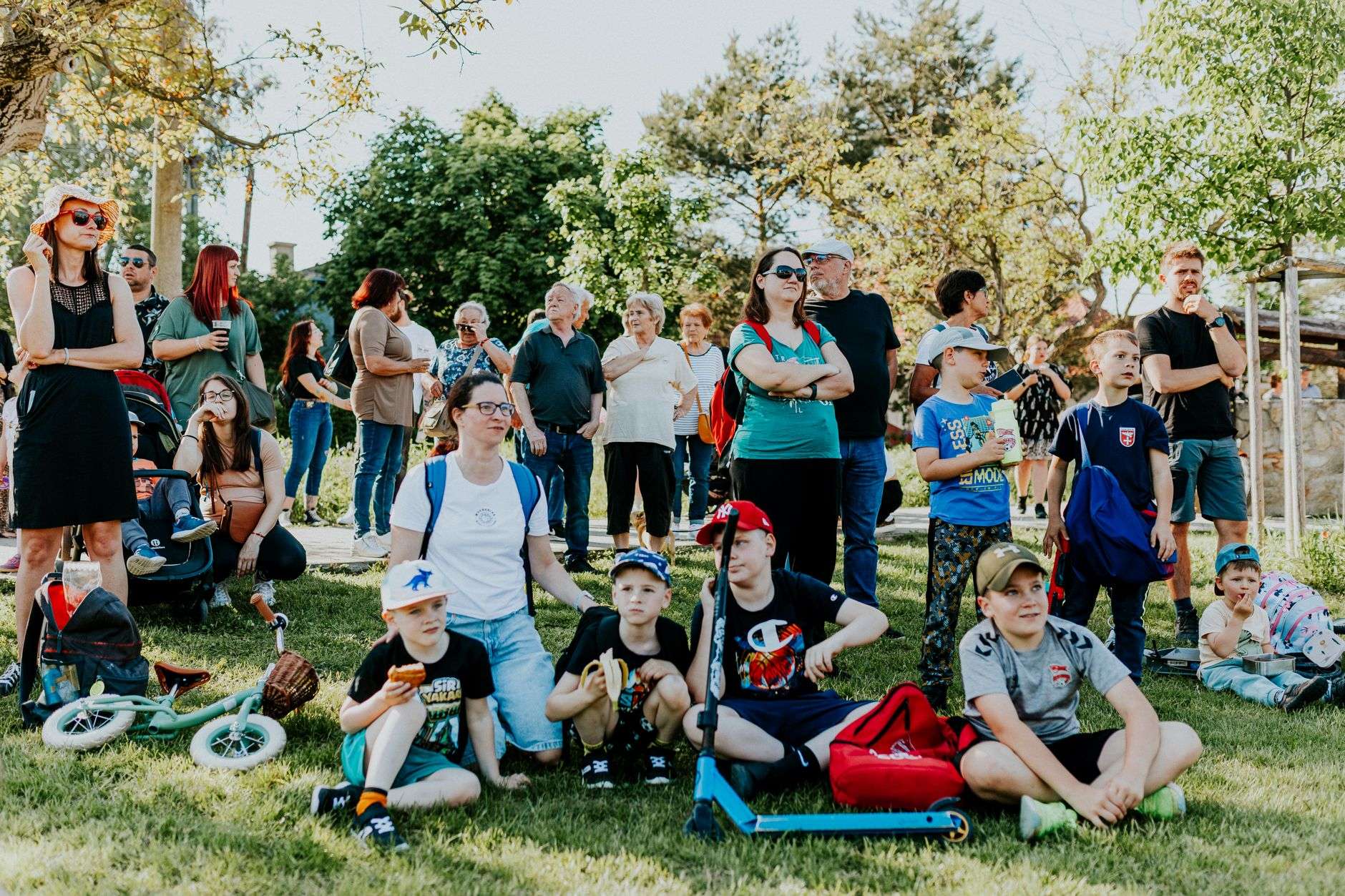 Families gathered outdoors at a community awareness event in a park