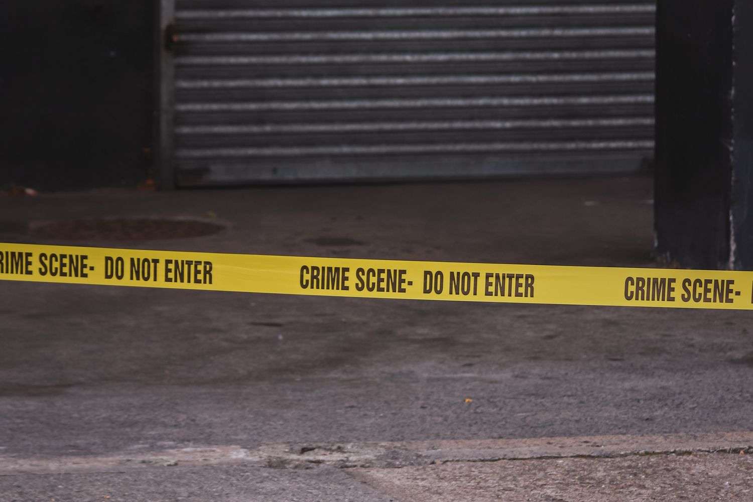 Yellow police tape blocking a downtown street during a police investigation
