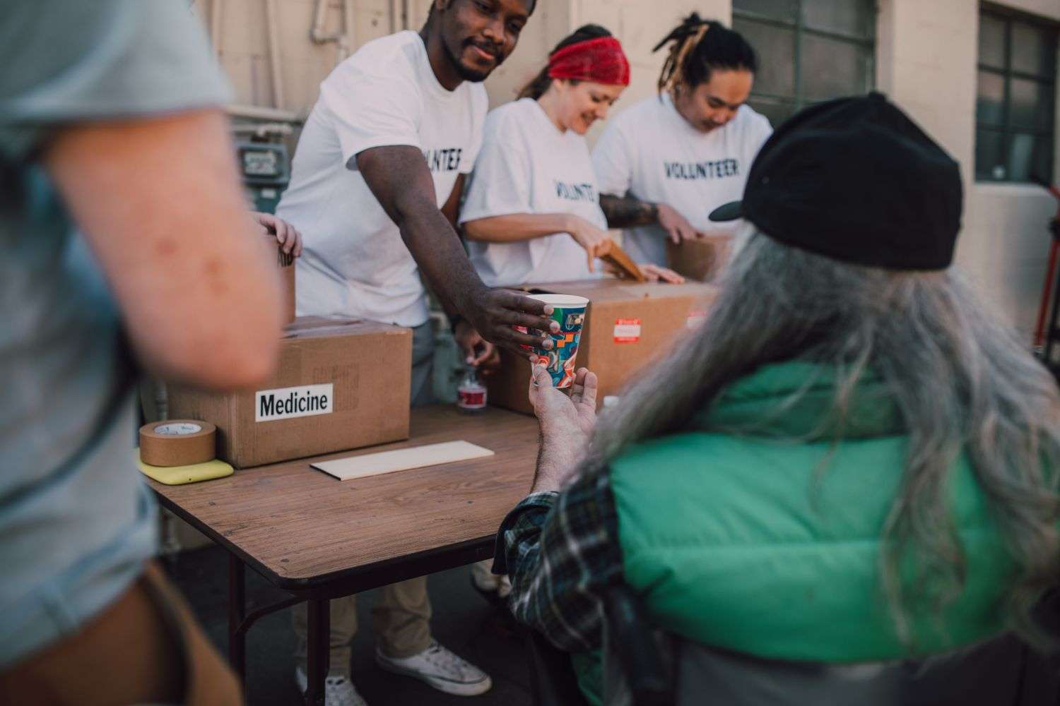 Volunteers organizing donated household supplies for families in need