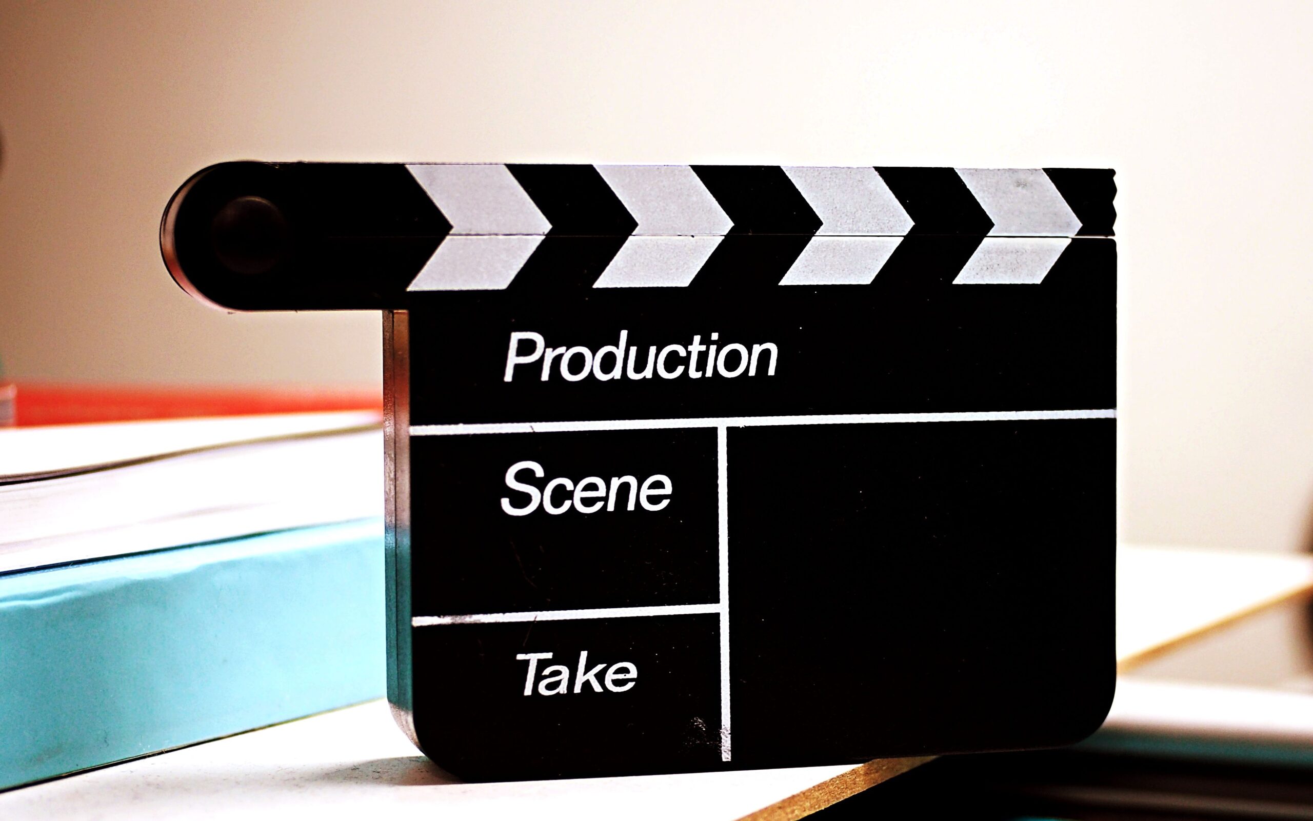 Film clapperboard reading Production, Scene, and Take on a desk