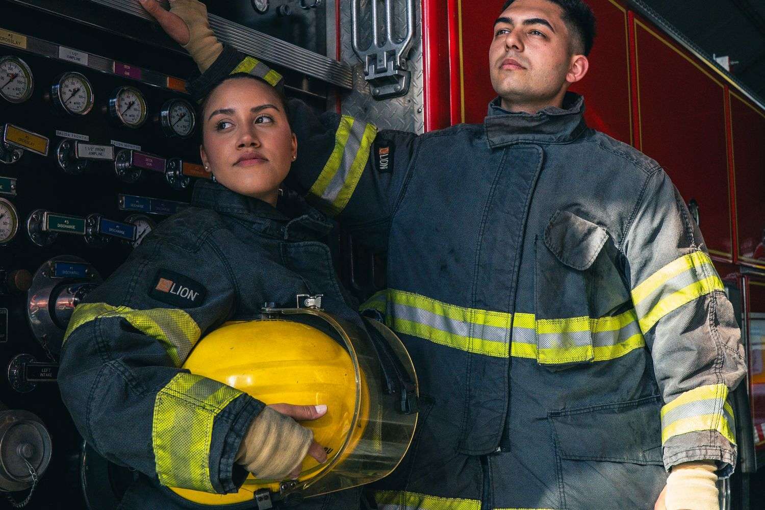 Firefighters wearing turnout gear outside a fire station in Alabama