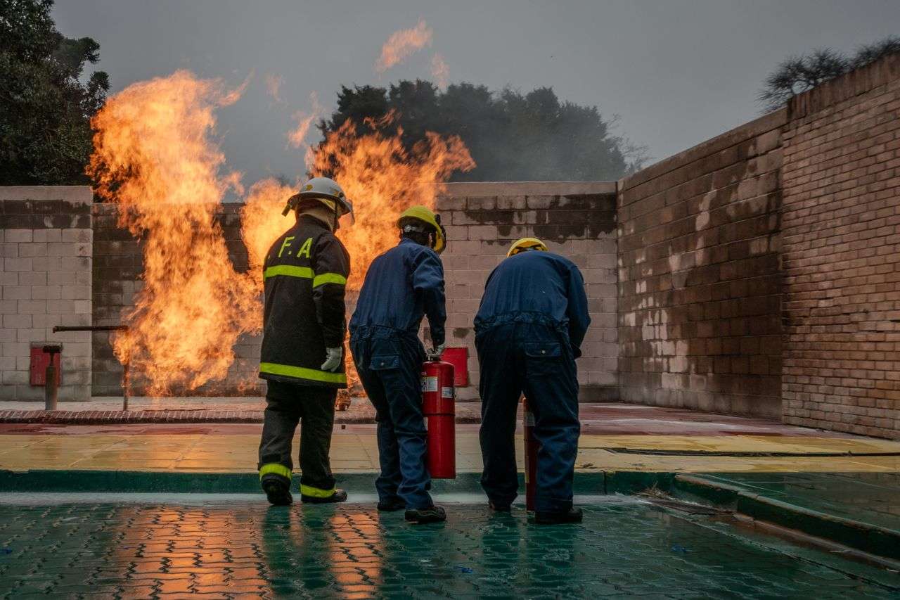 Firefighters using an extinguisher during a training exercise