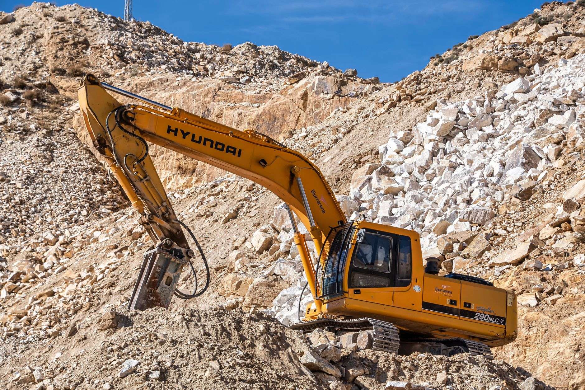 A yellow excavator operating at a construction site