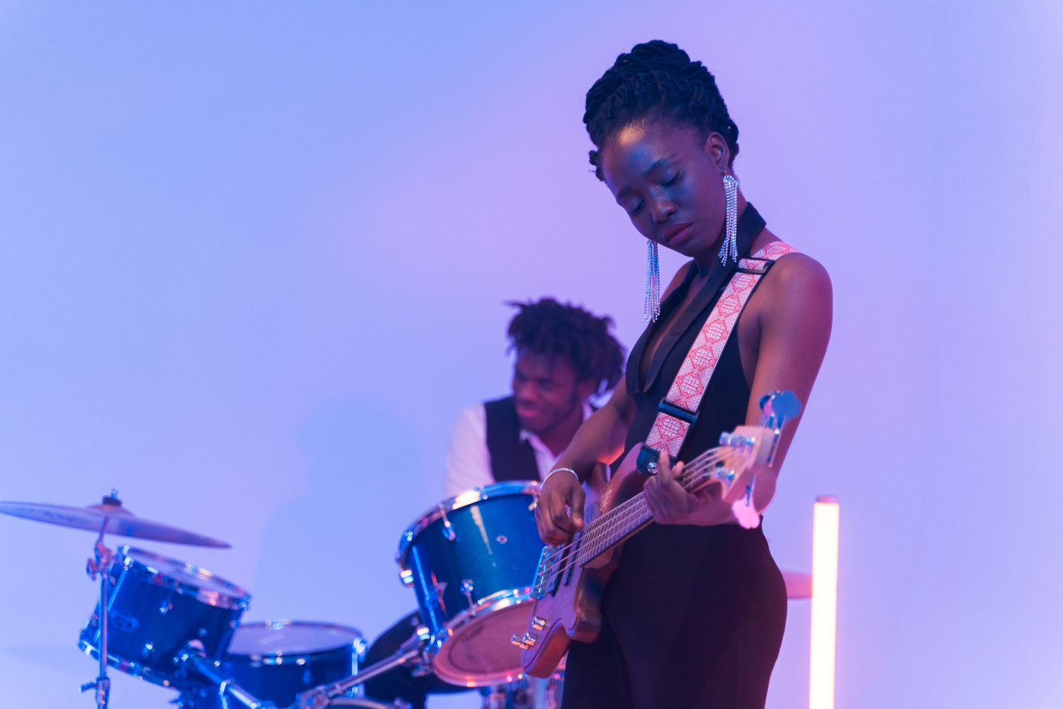 Musician playing an electric bass guitar during a live funk performance
