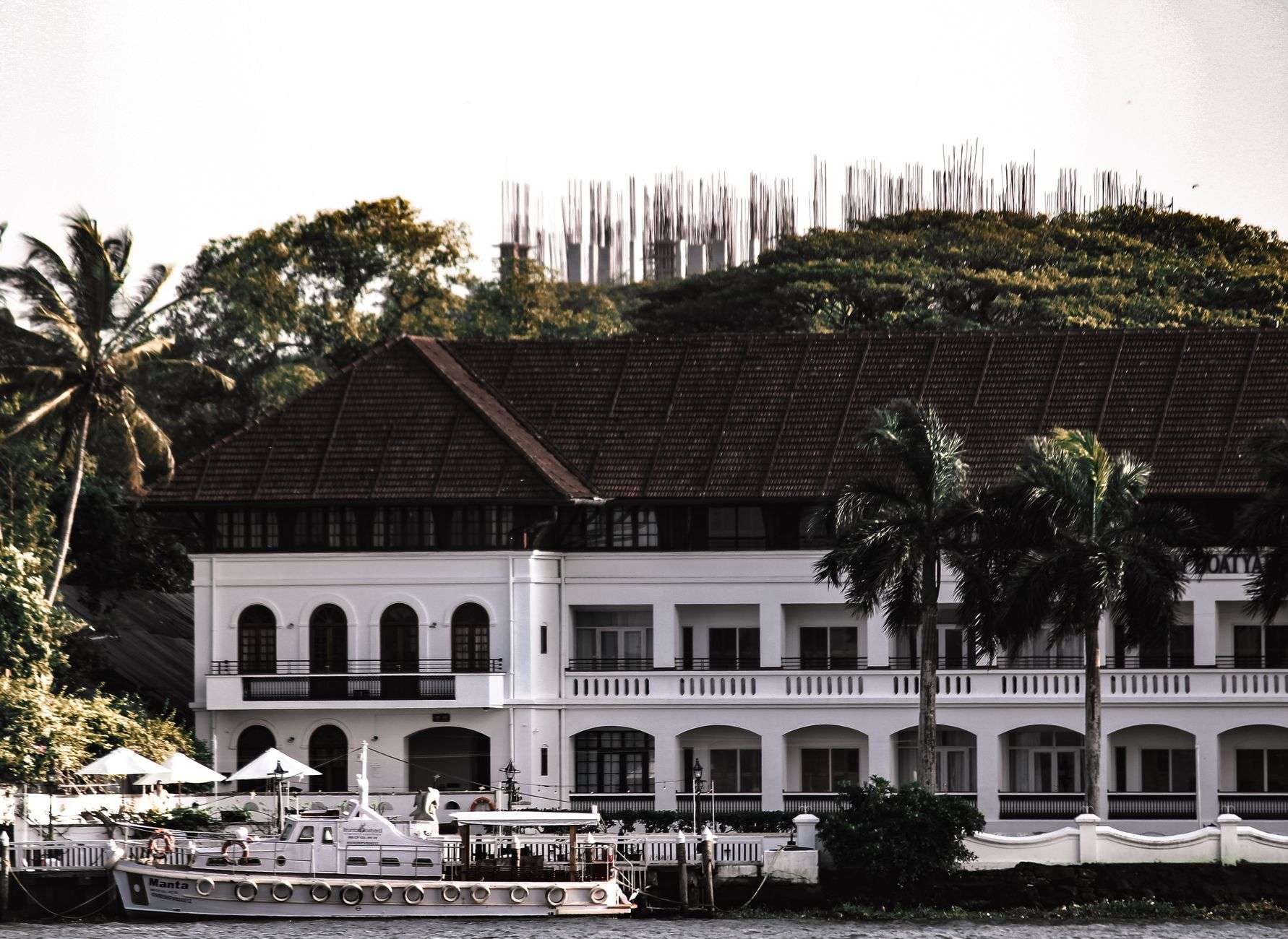 A waterfront resort hotel property with landscaped grounds