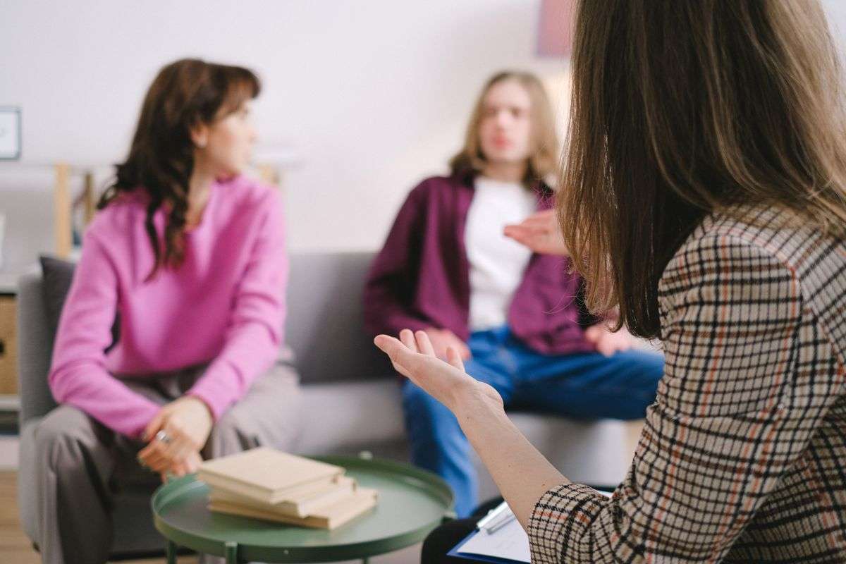 Group therapy session where participants sit in a circle sharing during addiction recovery counseling