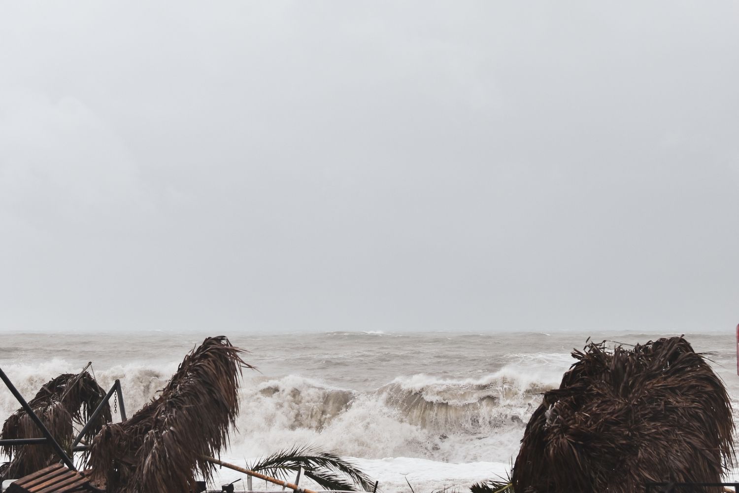 Large waves hitting a beachfront during a coastal storm