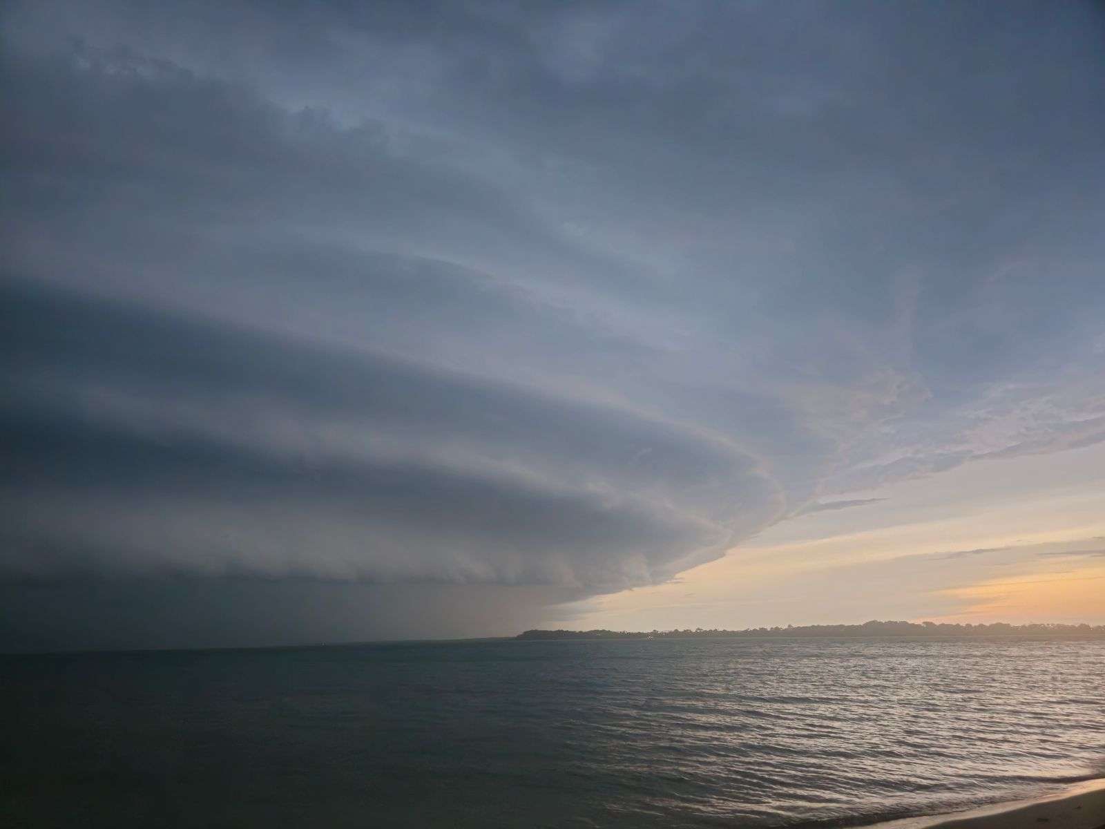 Dark storm clouds gathering over coastal waters