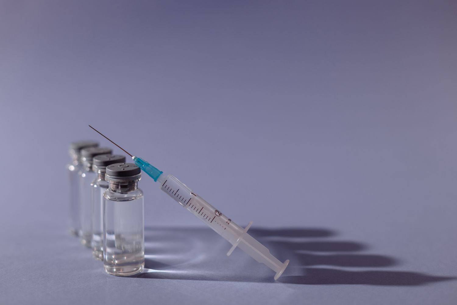 A COVID-19 vaccine vial drawn into a syringe