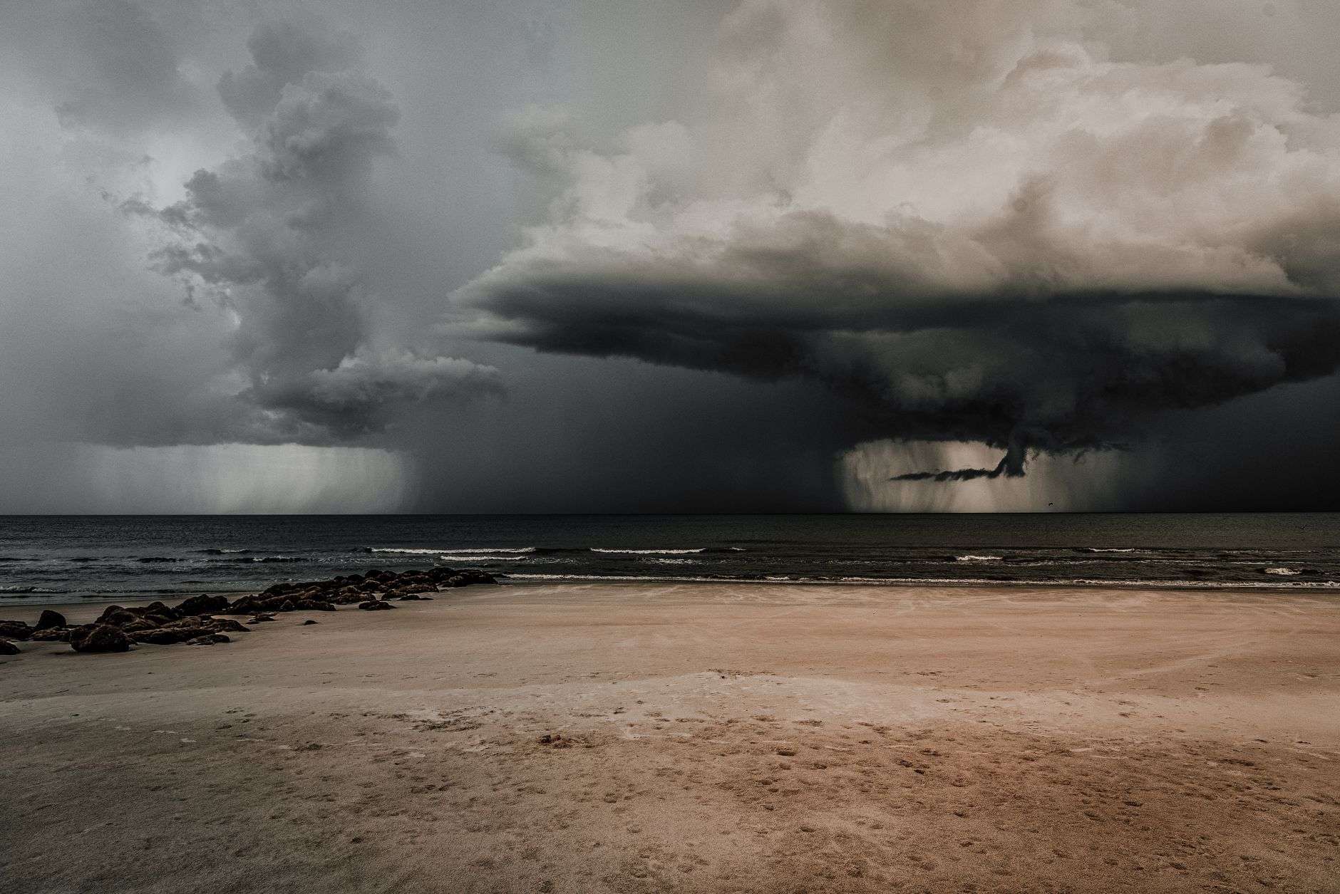 Dramatic storm clouds building over a coastline