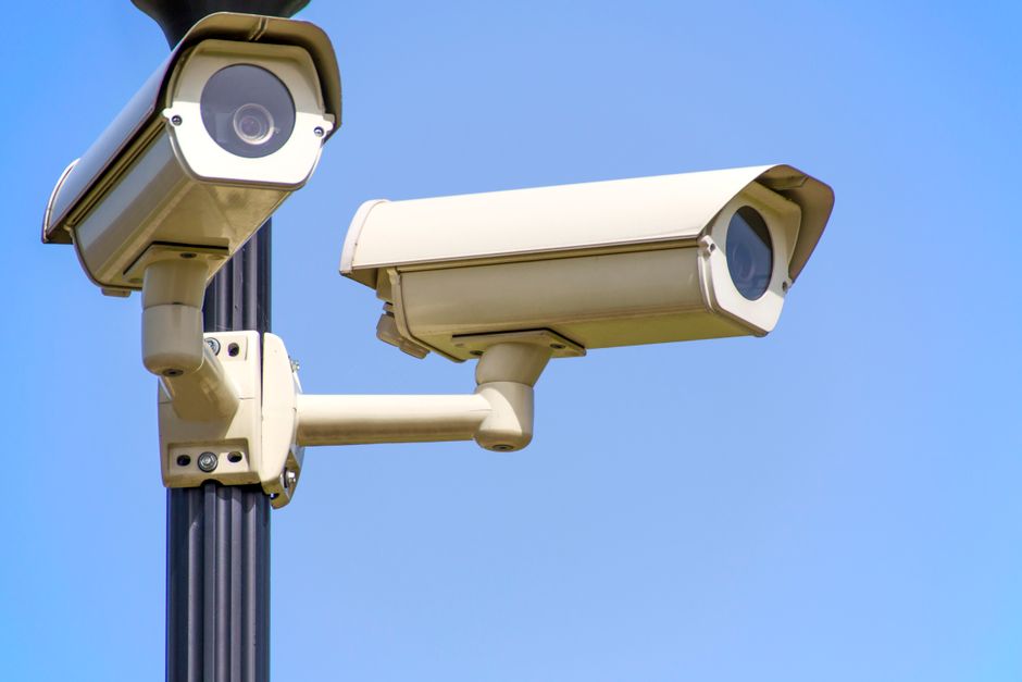 A license plate reading camera mounted on a pole along a public street
