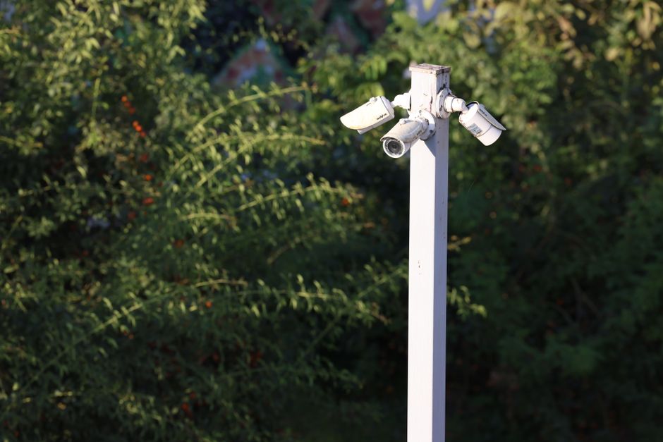 License plate reader camera mounted on a pole along a coastal street