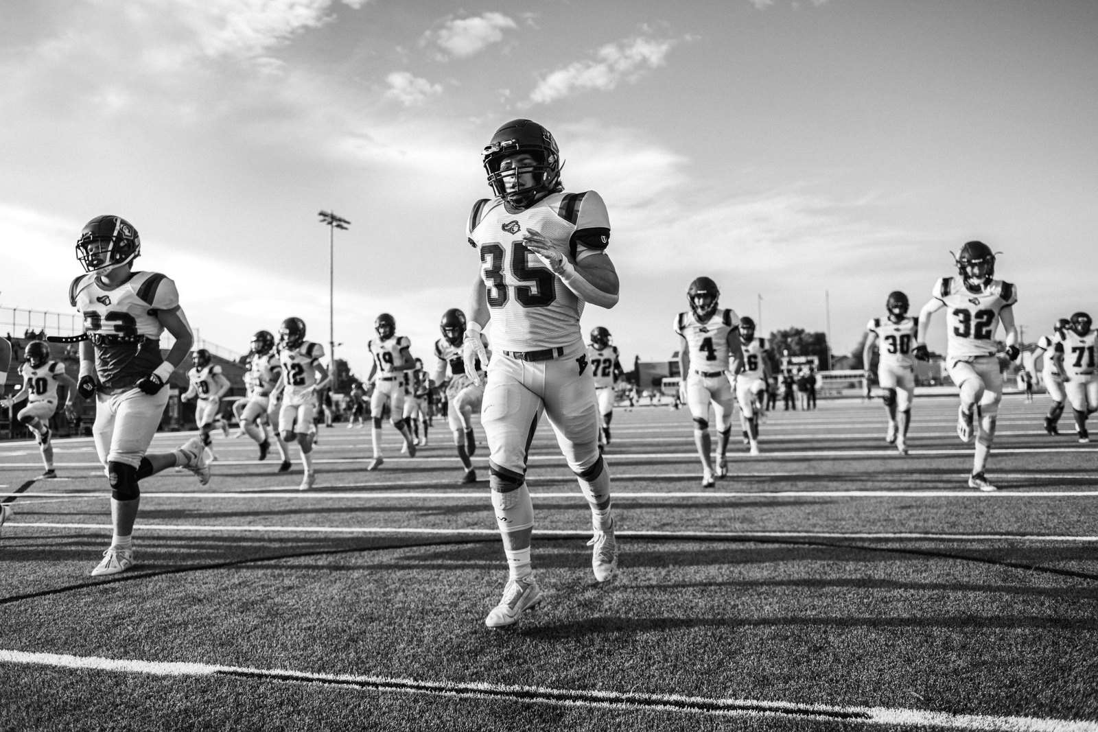High school football players take the field to open a season