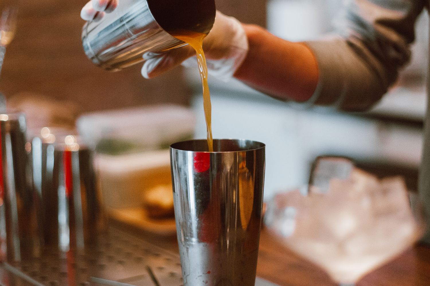 Bartender preparing a craft cocktail in a chilled glass