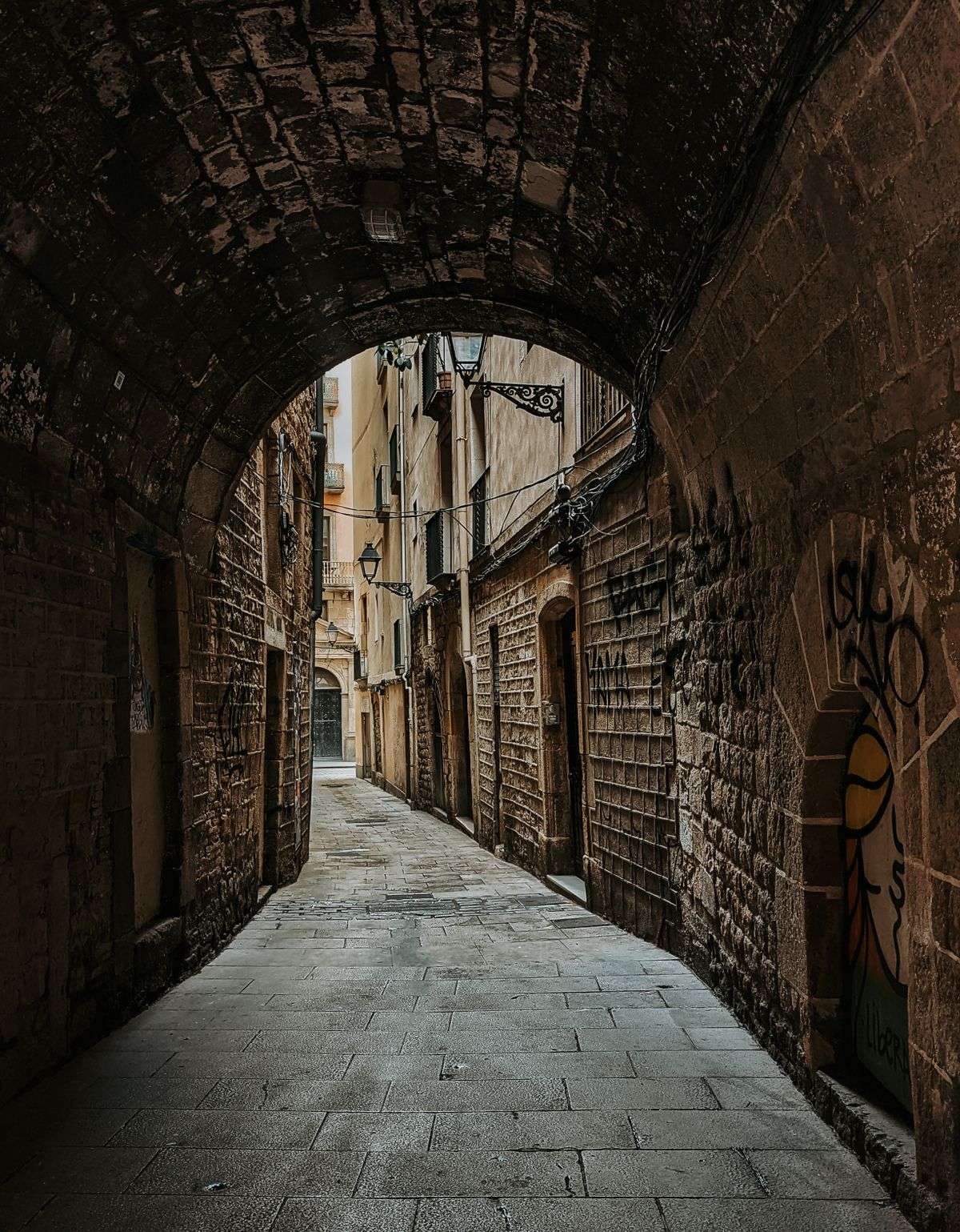 A narrow historic alley with old shanties, evoking Mobile's Spanish Alley district